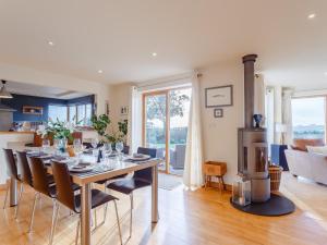 a dining room and living room with a table and chairs at 4 Bed in Wembury 54383 in Wembury