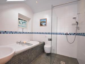 a bathroom with a shower and a sink and a toilet at 4 Bed in Wembury 54383 in Wembury