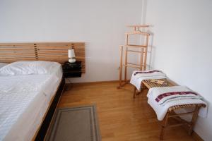 a bedroom with a bed and a ladder and two chairs at Pensiunea Anastasia in Jurilovca