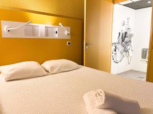 a bedroom with a bed with a drawing on the wall at ibis budget Marseille Vieux Port in Marseille