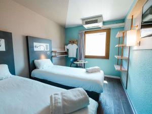a hotel room with two beds and a window at ibis budget Marseille Vieux Port in Marseille +80 photos