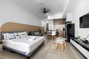 a bedroom with a large bed and a kitchen at Alinea Suites Shah Alam by Sleepy Bear in Shah Alam +107 photos