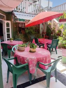 a group of tables with pink table cloths on a patio at Habitación Matrimonial - Parejas - Frente al mar in Estación El Salto
