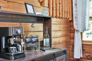 a bottle of wine sitting on a counter in a kitchen at Secluded Log Cabin with Hot Tub Fire Pit Game Room in Newfoundland