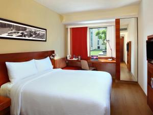a bedroom with a large white bed and a window at ibis Chennai City Centre - An Accor Brand in Chennai +70 photos
