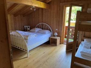 - une chambre avec un lit dans une maison en bois dans l'établissement Chalet pour 8 avec Wifi à Samoëns - FR-1-846-36, à Samoëns