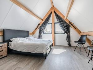 a bedroom with a bed and a large window at Thatched bungalow with private terrace in Schaluinen