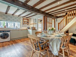 a kitchen and dining room with a table and chairs at 3 Bed in Godshill Wood 94495 in Godshill