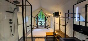 a room with a bed in a tent with a window at Papaya Resort Nong Khiaw in Nongkhiaw