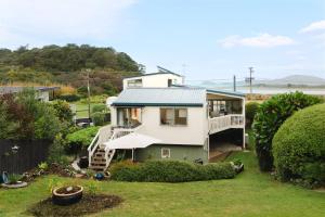 an aerial view of a house with a yard at BEACH Baby Cottage! in Ngunguru