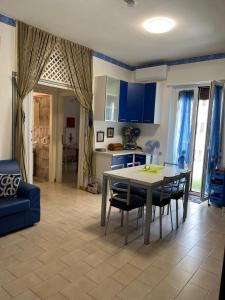 a kitchen and dining room with a table and chairs at Appartamento a 20 metri dal mare San Salvo Marina in Marina di Montenero