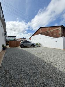 a car parked in a driveway next to a building at Casa Blu - Vacation home in Chitre in Chitré