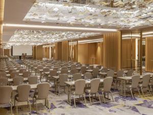 a large room with rows of tables and chairs at Mövenpick Hotel Istanbul Bosphorus in Istanbul +129 photos