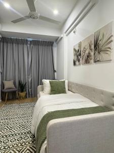 a bedroom with two beds and a ceiling fan at Nala Host- 2BR Beachfront Apartment in Male City