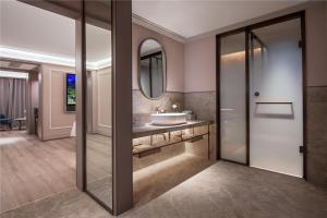 a bathroom with a sink and a mirror at Mercure Suzhou Shilu Shantang in Suzhou +27 photos