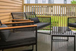 a patio with two chairs and a table at Westcott 2BR 3 Bed Apt in Mansion mins to SU JMA Dome in Syracuse