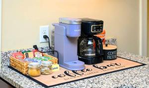 a coffee maker on a counter with a box of food at Westcott 2BR 3 Bed Apt in Mansion mins to SU JMA Dome in Syracuse +34 photos