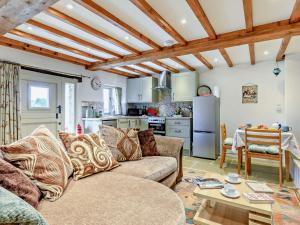 a living room with a couch and a table at 1 Bed in Cullompton 92104 in Kentisbeare