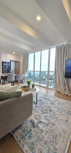 a living room with a couch and a table at Nala Host- 2BR Beachfront Apartment in Male City