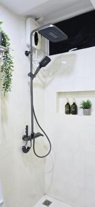 a shower in a bathroom with a shower head at Nala Host- 2BR Beachfront Apartment in Male City +64 photos