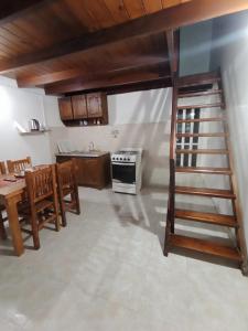 a kitchen with a table and a staircase in a room at Departamento en Dolores Precio exclusivo en entrada a Parque Termal in Dolores +5 photos
