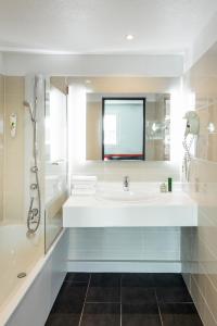 a white bathroom with a sink and a shower at ibis Styles Antony Paris Sud in Antony