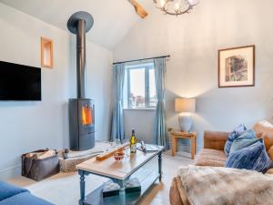 a living room with a couch and a fireplace at 1 Bed in Cheltenham 95793 in Tirley