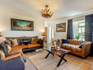 a living room with two couches and a table at 4 Bed in Huna 95612 in Huna