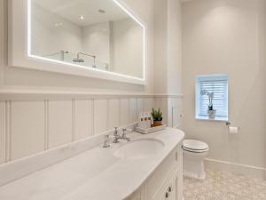 a white bathroom with a sink and a toilet at 2 Bed in Cockermouth 95716 in Broughton Moor