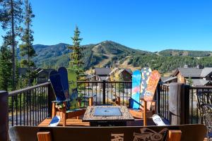 a deck with several snowboards on a balcony with mountains at Dreamcatcher at Lakota home in Winter Park
