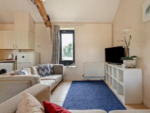 a living room with a couch and a tv at 2 Bed in Sedgehill 96237 in Sedghill