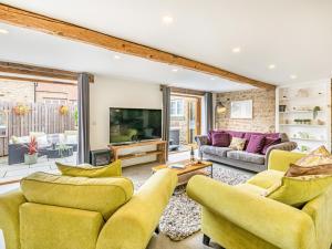 a living room with yellow chairs and a tv at 1 Bed in Richmond 93264 in Richmond