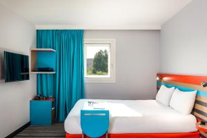 Postel nebo postele na pokoji v ubytování ibis Styles Antony Paris Sud