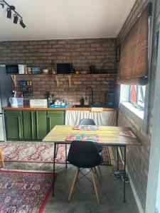 a kitchen with a wooden table with two chairs at Your home in the Cape in Cape Town +8 photos
