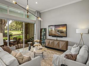 a living room with a couch and a tv at Lake Jovita 3BR Golf Villa including Black Diamond Access in Dade City