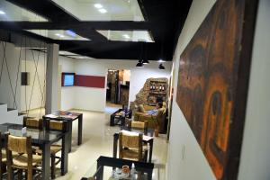 a room with a table and chairs and people in a room at Hotel Pucará in La Rioja