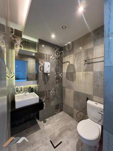 a bathroom with a toilet and a sink at Stirling Homestay by Evernent in Miri