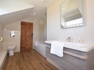 a bathroom with a sink and a toilet and a mirror at 5 Bed in Padstow TBART in Saint Issey +25 photos
