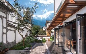 a courtyard of a house with a view of the mountains at Wangye Homestay Collection, Dali Ancient Town in Dali Ancient Town