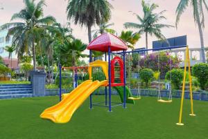 a playground with a slide in a park at Hudson Resorts in Pondūr
