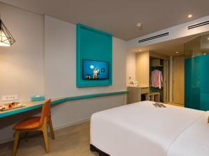 a bedroom with a bed and a desk with a chair at ibis Styles Nha Trang in Nha Trang
