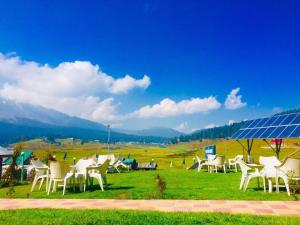 a group of chairs on a field with a solar panel at Pine View Resort in Gulmarg