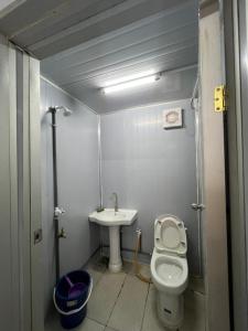a small bathroom with a toilet and a sink at Homestay D'Pengkalan in Masjid Tanah