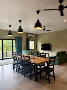 a dining table and chairs in a living room at Buddha Resort in Catagnan