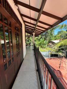 a balcony of a house with a wooden door at Villa RISO in Boossa