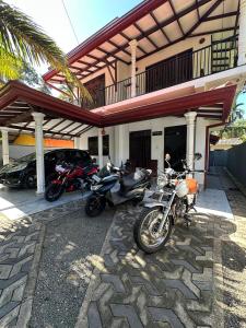 a group of motorcycles parked in front of a building at Villa RISO in Boossa