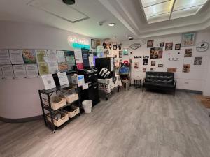 a room with a store with signs on the wall at 溫情自助旅店 in Taoyuan