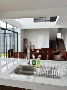 a kitchen sink with a dish drying rack in it at Casa Laguna in Trujillo