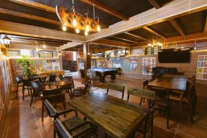 a restaurant with tables and chairs and a pool table at Villa 750sqm with Pool and BBQ in Hue in Cồn Giả Viên