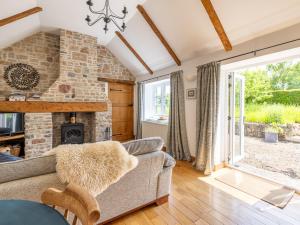 a living room with a couch and a fireplace at 1 Bed in Wedmore CRIBB in Wedmore